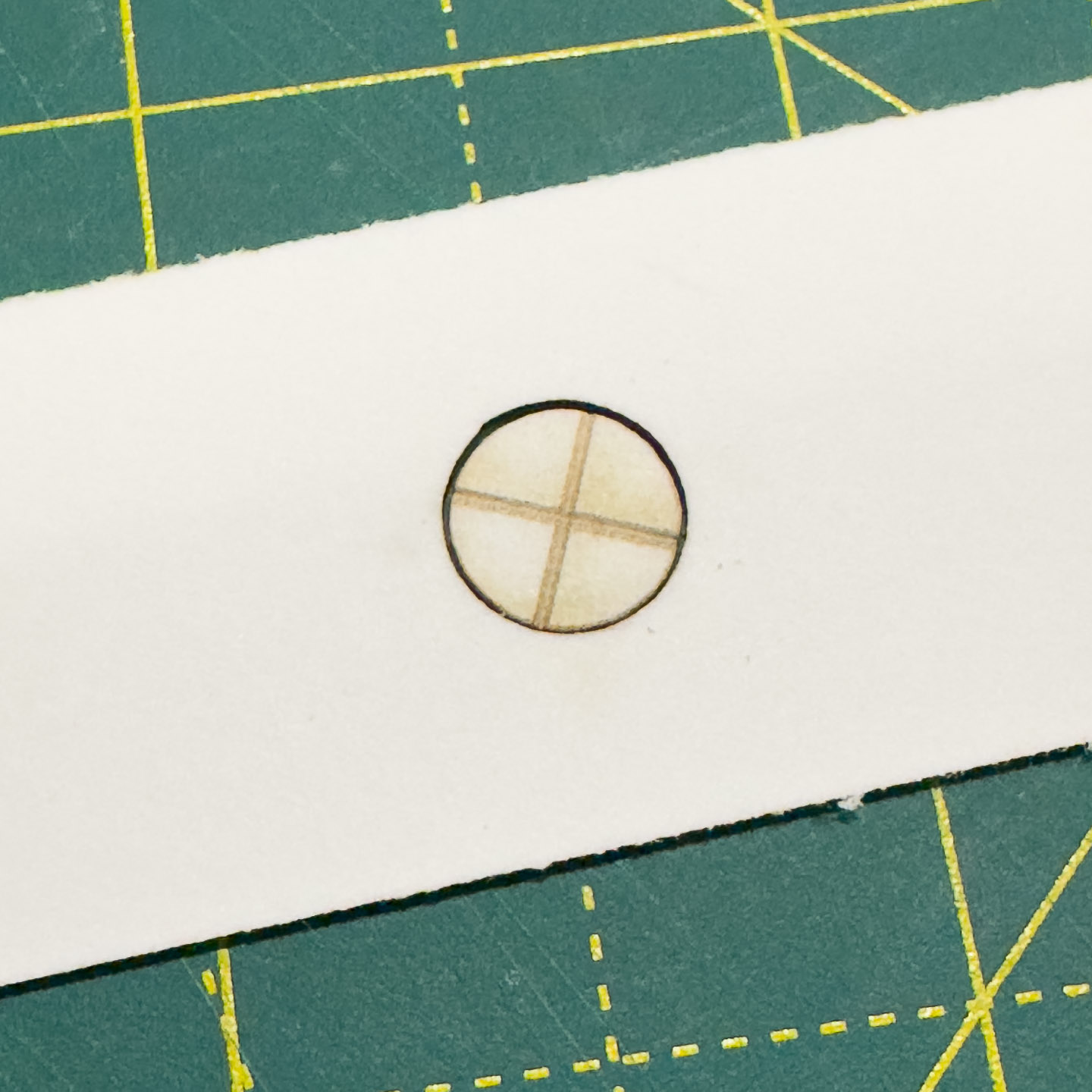 Etched paper axle in a paper bushing.