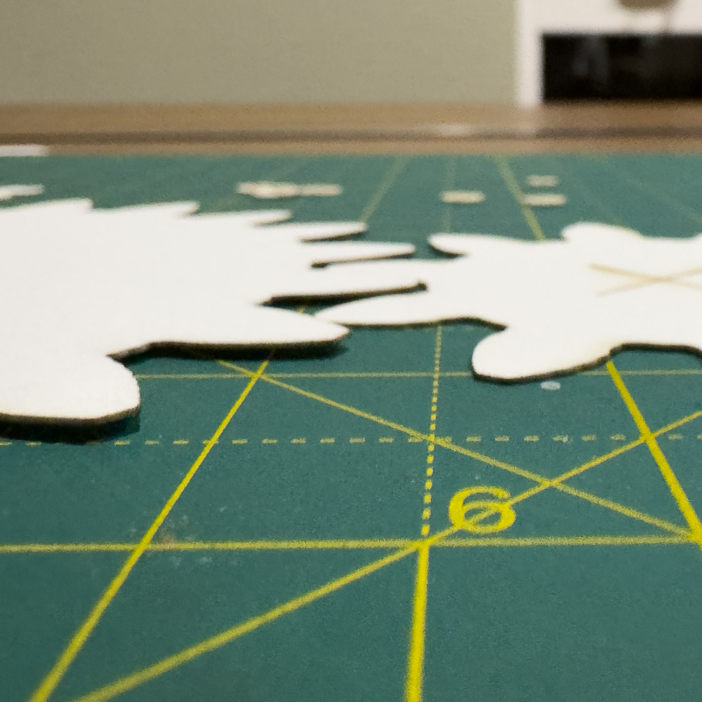 Two paper gears edge-on showing warping